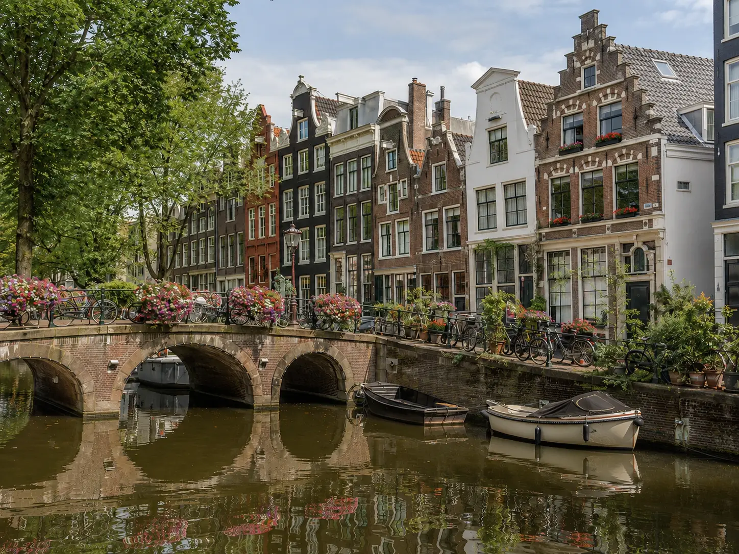 Dutch canal with facades, bicycles, flowers and small boats