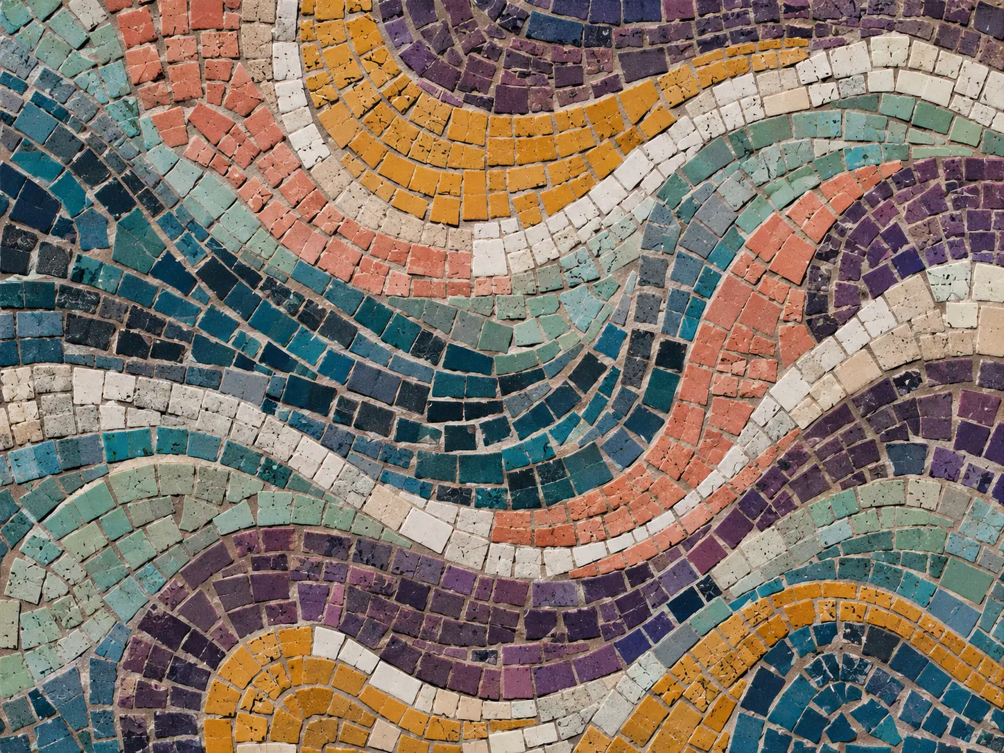 Handmade mosaic of irregular matte tiles in flowing bands of petrol, coral and saffron