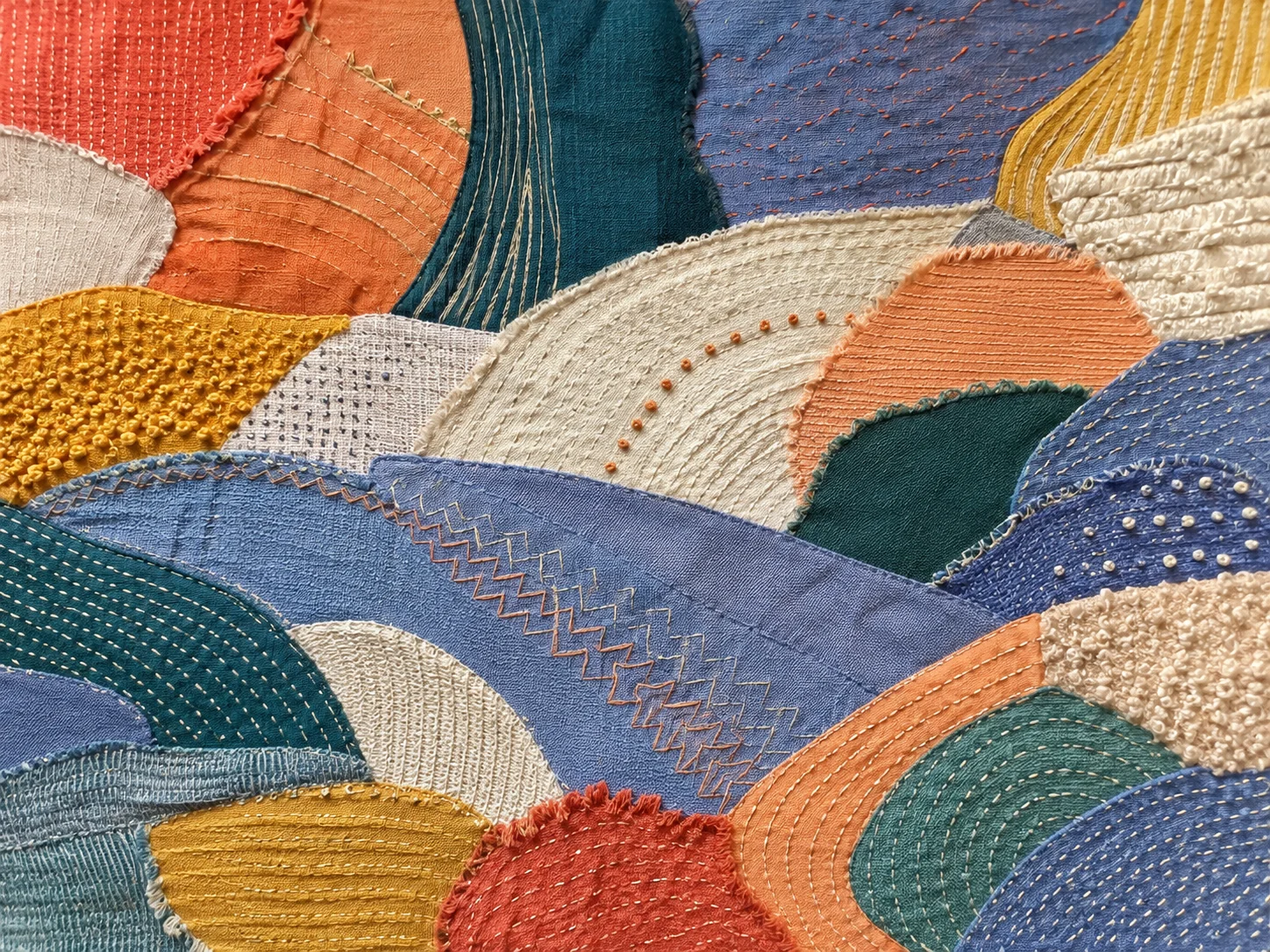 Layered textile mosaic with embroidered arcs in petrol, blue, apricot and ochre